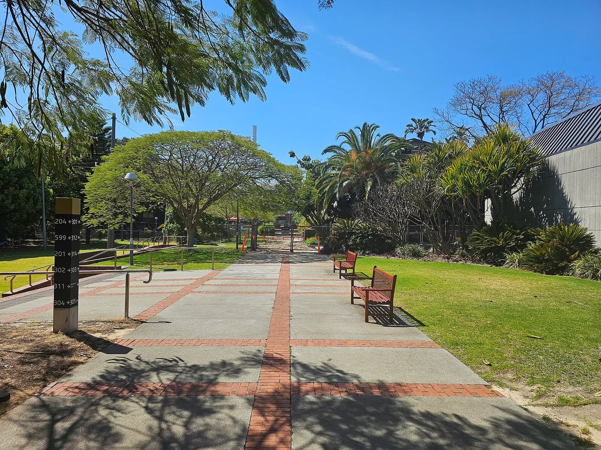 A paved walkway through gardens at Curtin University's Bentley campus