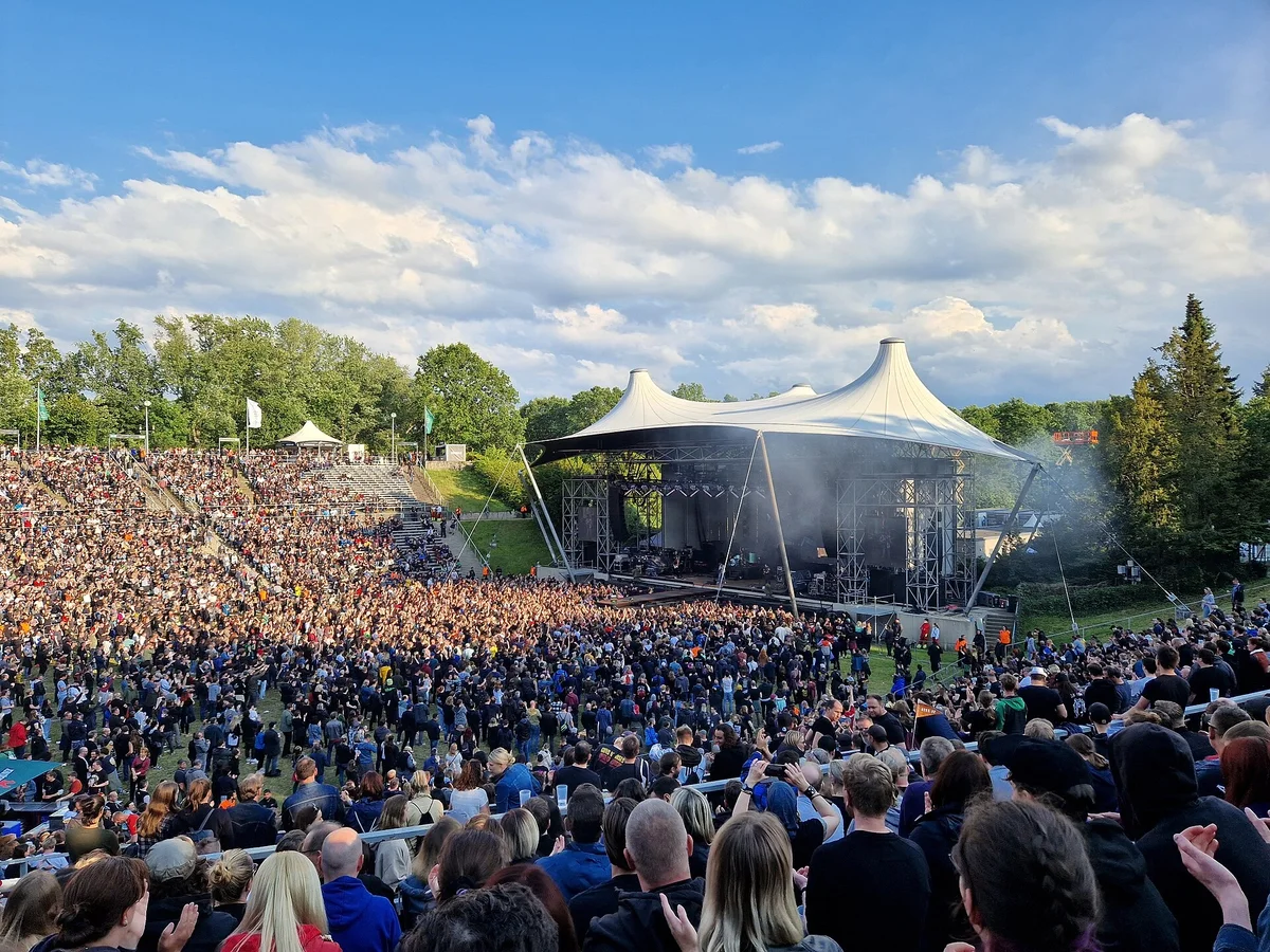 A huge crowd at an outdoor amphitheatre for a Weezer concert in Berlin