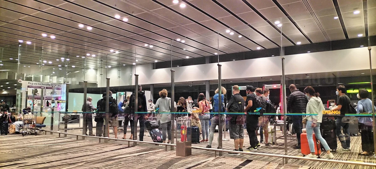 Travellers queuing inside Changi Airport Terminal 3