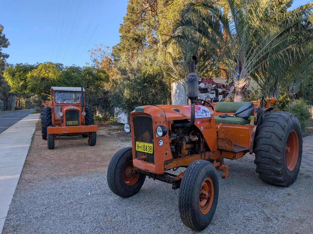 Two tractors on the road heading toward Whiteman Park