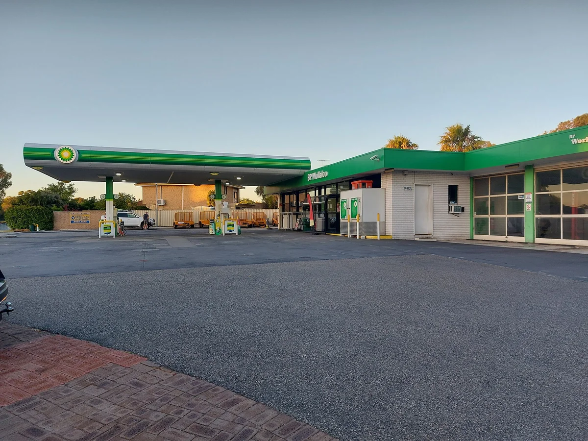 A BP service station on the corner of Koorana Road and Dampier Avenue in Mullaloo, Western Australia, with its price board and forecourt in daylight
